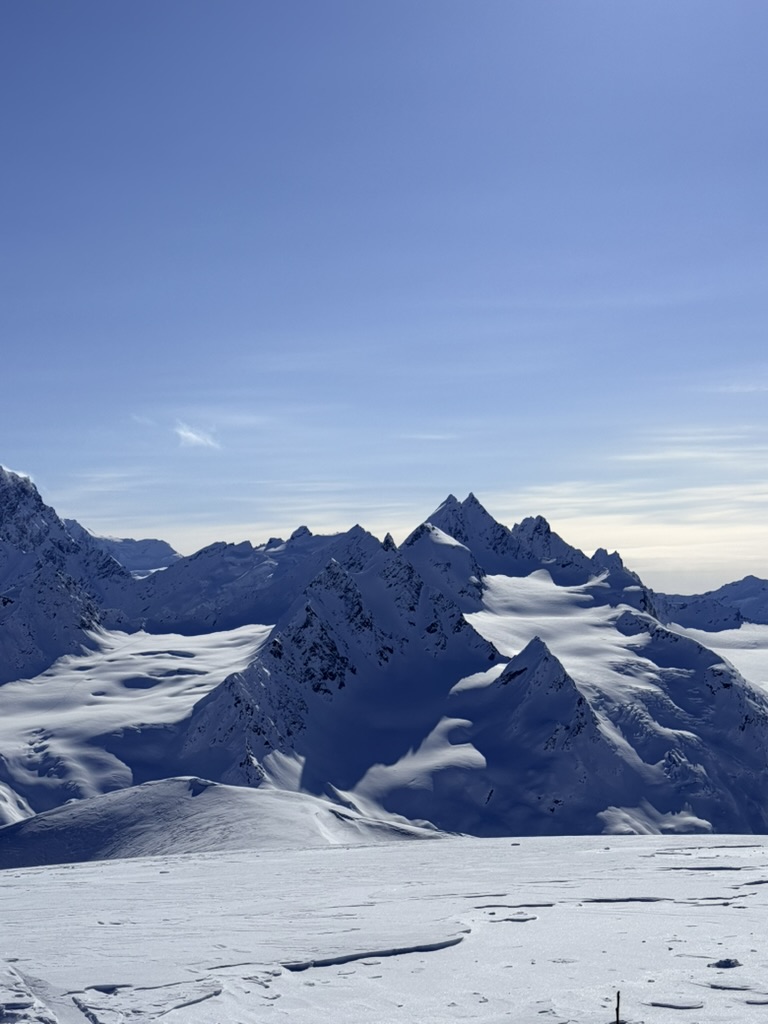 Snow-covered mountain peaks beneath a blue sky