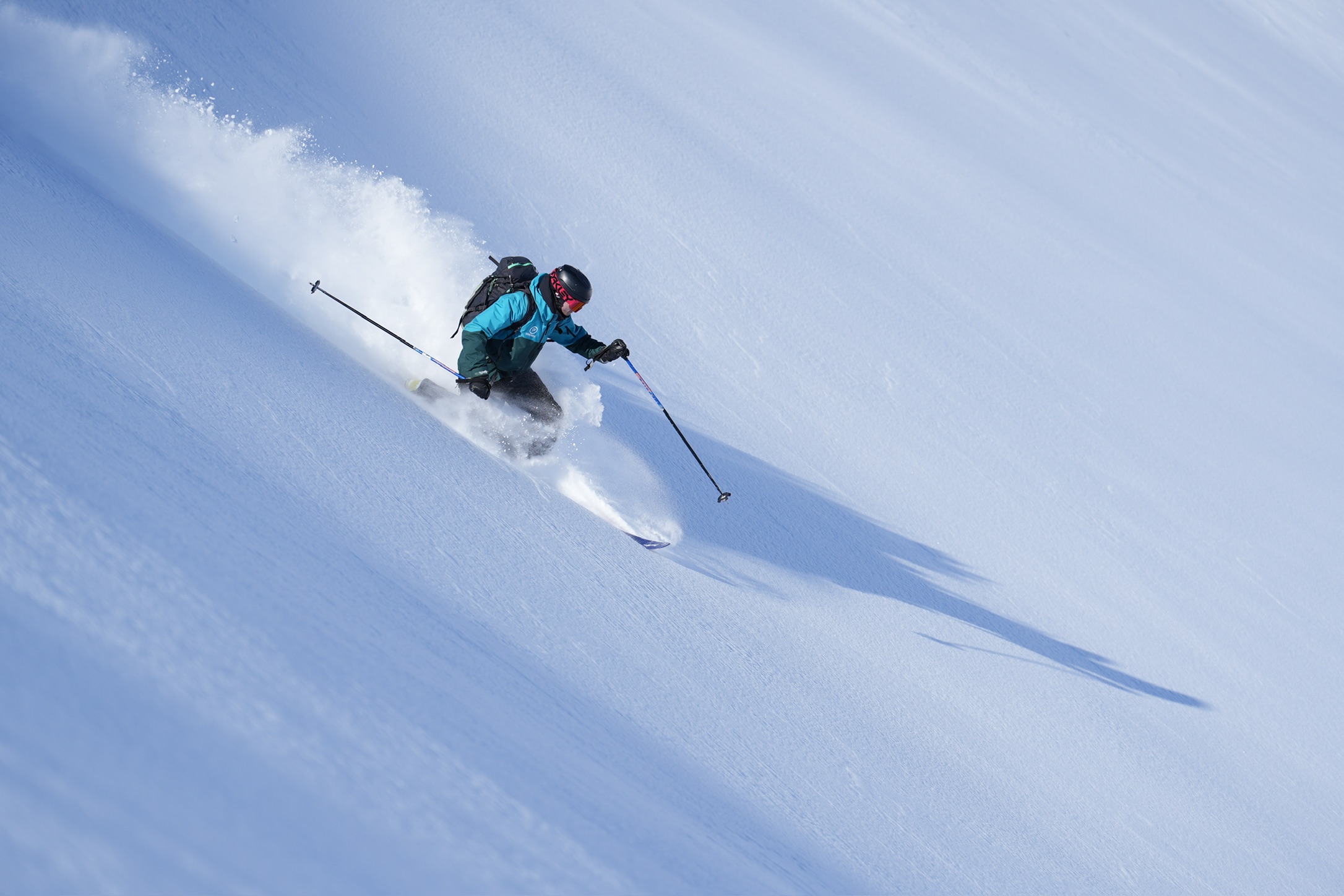 Skier making a turn through fresh snow