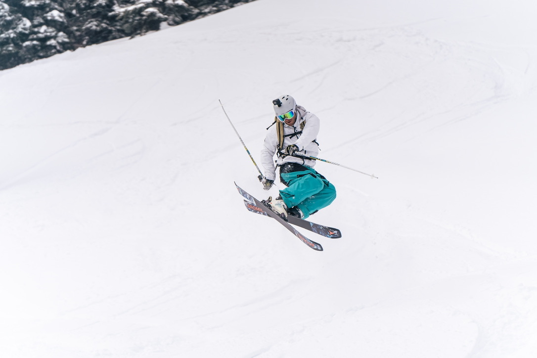 Skier airborne above a snowy slope
