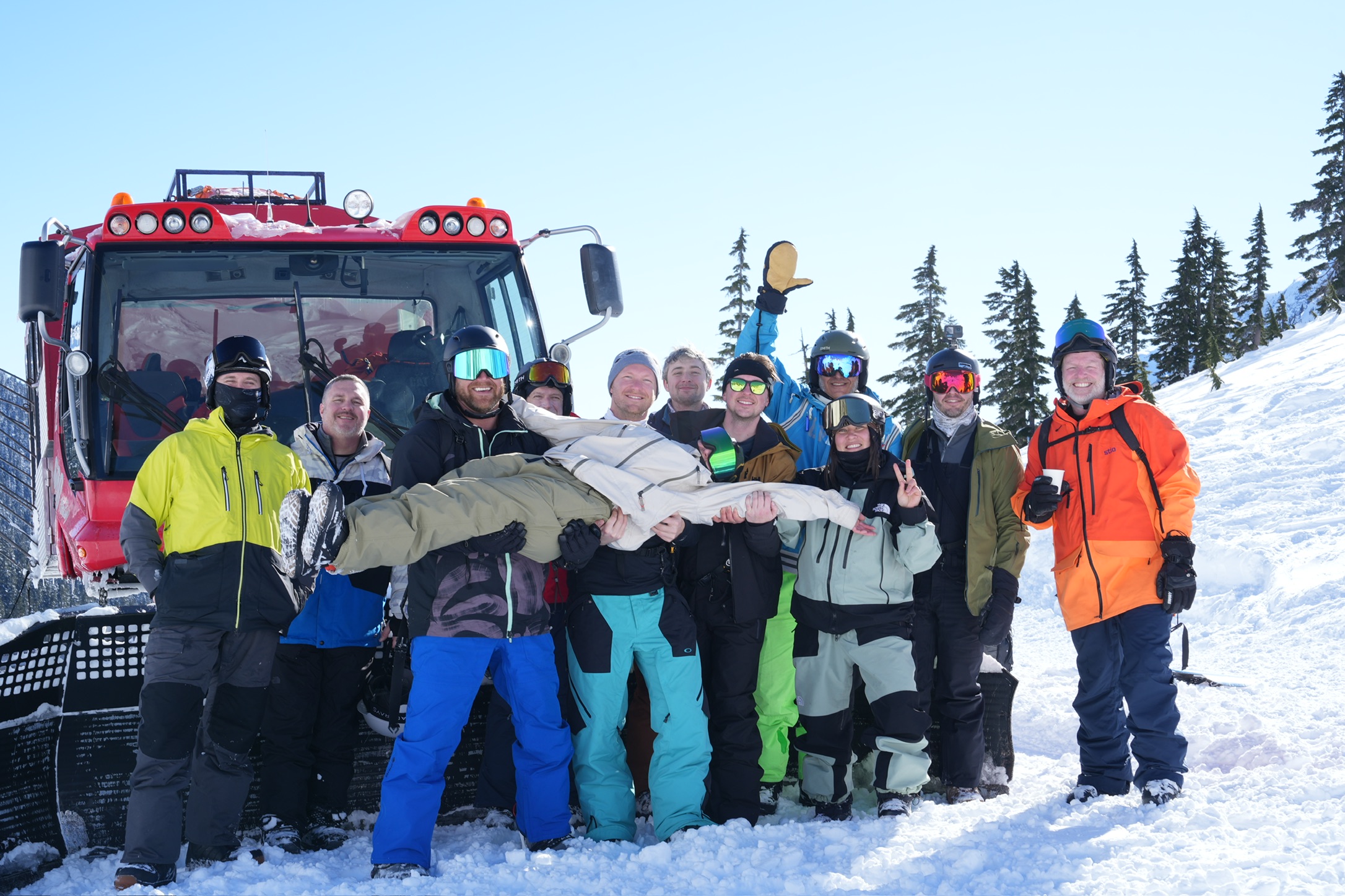 The H2 crew and friends gathered beside a snowcat